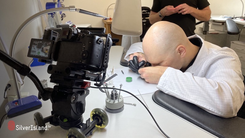 Technician looking closely at the watch mechanism