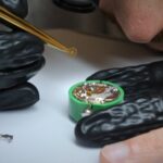 watching at a technician removing the gears from a watch TWR Watch Repairs.