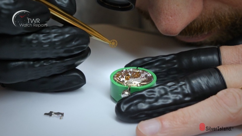 watching at a technician removing the gears from a watch TWR Watch Repairs.